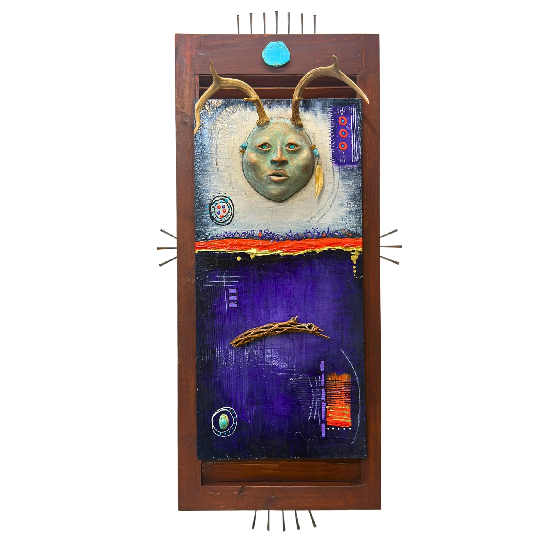 The Gatherer Dimensional mixed media wall work featuring a patina-rich ceramic face crowned with deer antlers, mounted on a vintage wood shutter with deep violet and molten orange acrylic painting, cholla, and hand-drawn symbols. By Michelle Bracewell.